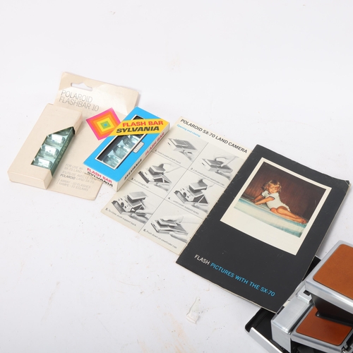 539 - A Polaroid SX-70 Land camera, with instruction pamphlet and 2 Flash Bars