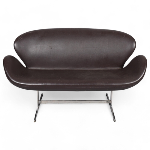 541 - A brown faux leather unholstered Swan sofa, in the manner of ARNE JACOBSEN, with polished aluminium ... 