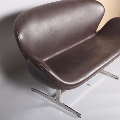 541 - A brown faux leather unholstered Swan sofa, in the manner of ARNE JACOBSEN, with polished aluminium ... 