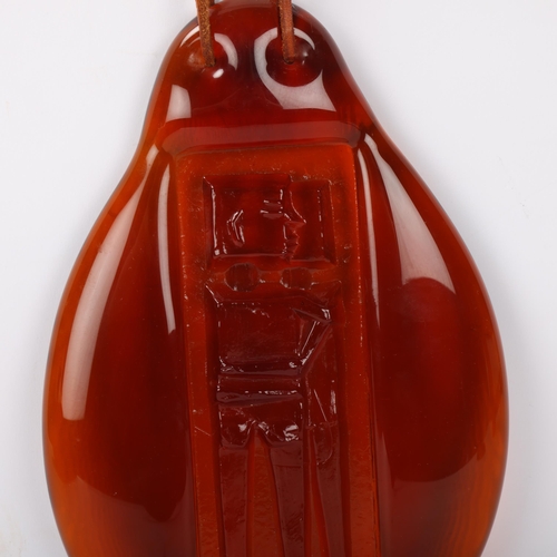 558 - ERIK HOGLUND for Boda a suncatcher in red glass and a design of a couple embracing, signed on the re... 