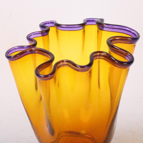 568 - An amber studio glass handkerchief vase, with amethyst glass rim, indistincly signed to base Mika Tu... 