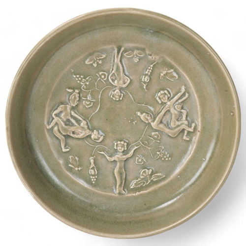 308 - A Chinese celadon glazed porcelain bowl, with relief moulded erotic scenes, diameter 16.5cm