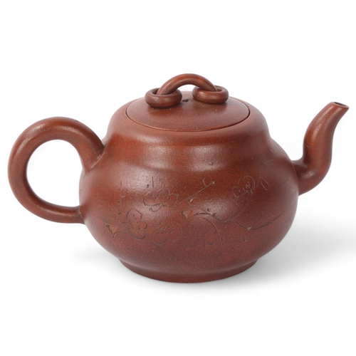 312 - A Chinese Yi Xing terracotta teapot with incised decoration, length 19cm