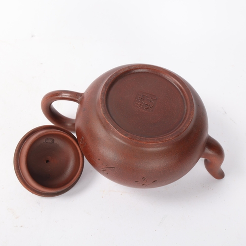 312 - A Chinese Yi Xing terracotta teapot with incised decoration, length 19cm