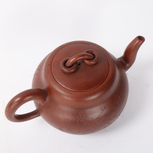 312 - A Chinese Yi Xing terracotta teapot with incised decoration, length 19cm