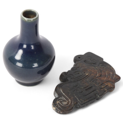 313 - A Chinese relief carved jade pendant, length 9.5cm, and a miniature blue glaze porcelain vase (2)