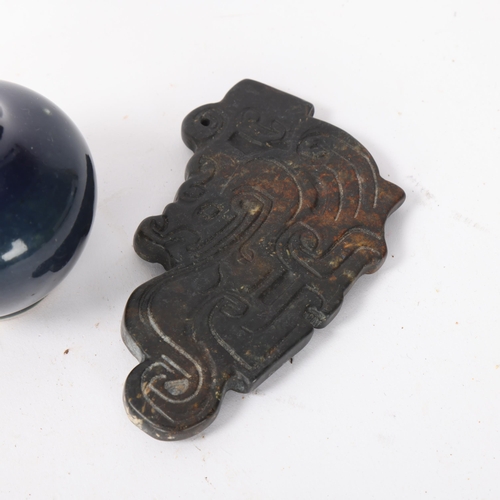 313 - A Chinese relief carved jade pendant, length 9.5cm, and a miniature blue glaze porcelain vase (2)