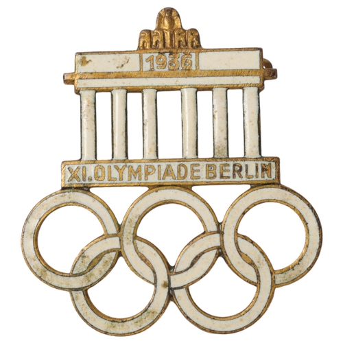 82A - A 1936 Berlin Olympics visitors badge,  base metal with gilt finish and infilled with white enamel m... 