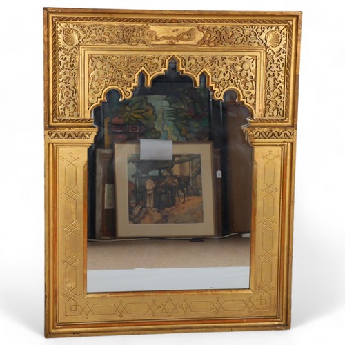 284 - An Islamic giltwood framed wall mirror, dated 1906 on label on reverse, 92cm x 71cm