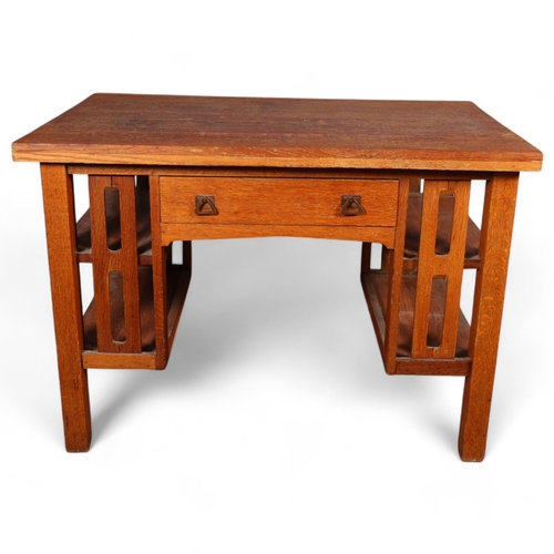 588 - An Arts and Crafts oak desk, attributed to L & J.G.Stickley, New York, with integral book shelves to... 