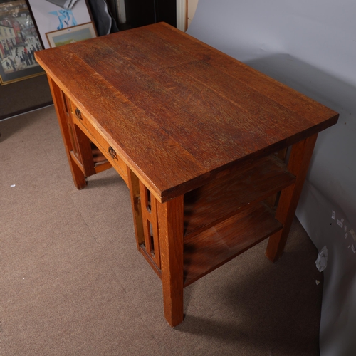 588 - An Arts and Crafts oak desk, attributed to L & J.G.Stickley, New York, with integral book shelves to... 