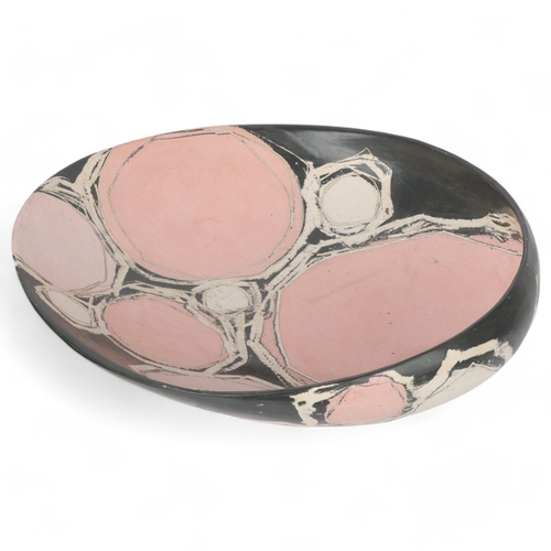 600 - CAROLYN GENDERS (born 1957), a large grey/white/pink earthenware dish burnished terra sigillata slip... 