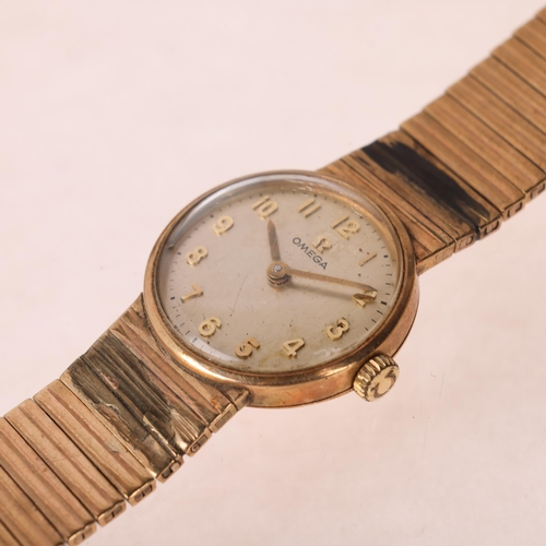 1041 - OMEGA - a lady's Vintage 9ct gold mechanical bracelet watch, ref. 7115513, circa 1968, silvered dial... 