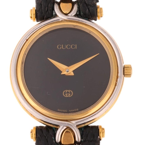 1051 - GUCCI - a lady's gold plated stainless steel 4500L quartz wristwatch, black dial with gilt dauphine ... 