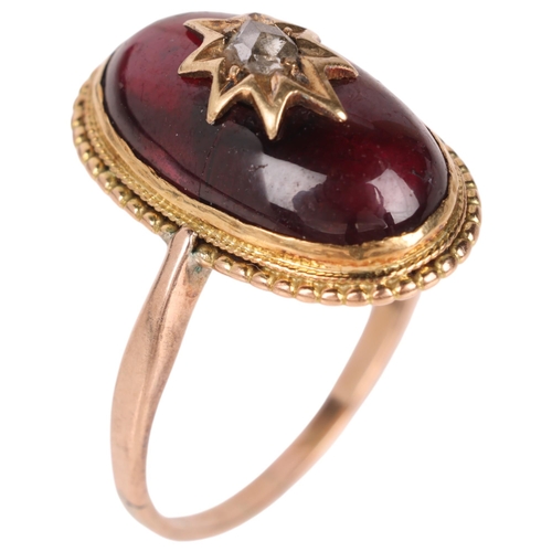 1106 - An Antique Victorian garnet and diamond mourning ring, circa 1880, set with foil-back oval cabochon ... 