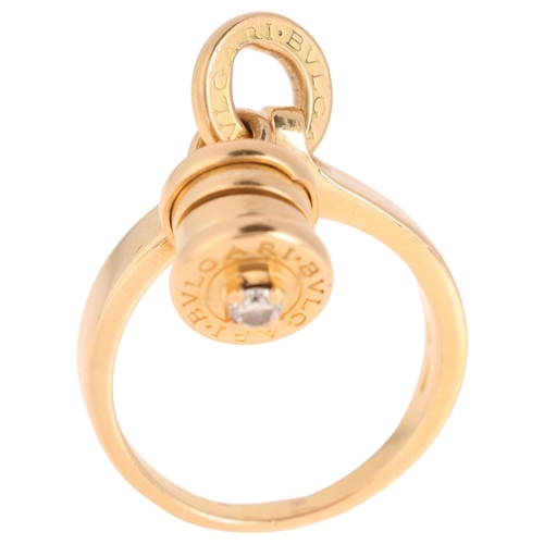 1120 - BULGARI - an 18ct gold diamond 'B.zero1' dangling barrel ring, the barrel signed Bvlgari and set wit... 