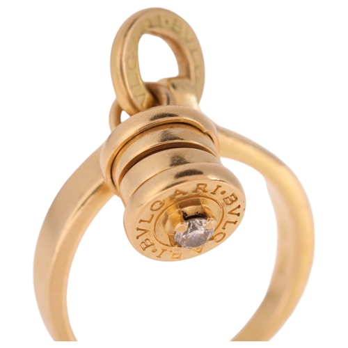 1120 - BULGARI - an 18ct gold diamond 'B.zero1' dangling barrel ring, the barrel signed Bvlgari and set wit... 