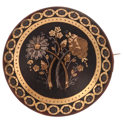 1123 - An Antique Victorian tortoiseshell bombe brooch, circular form and pique inlaid with silver and gold... 