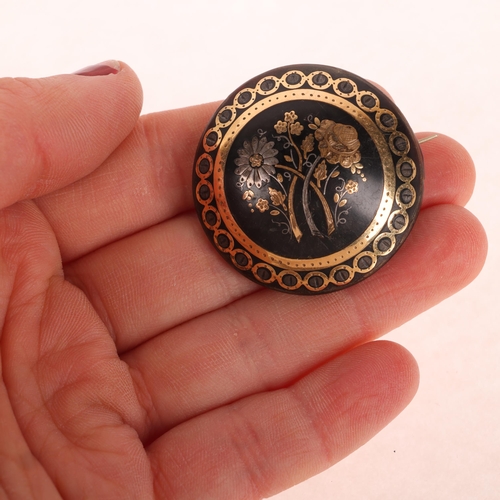 1123 - An Antique Victorian tortoiseshell bombe brooch, circular form and pique inlaid with silver and gold... 