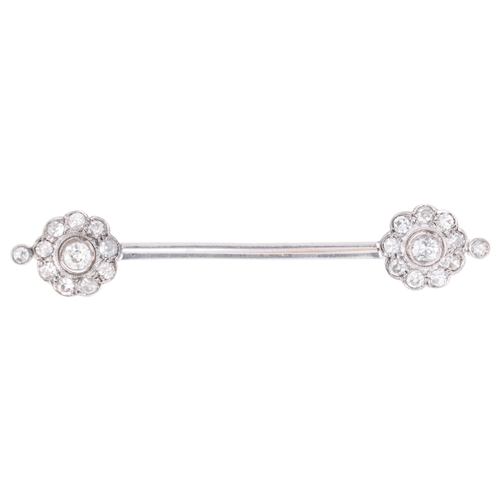 1132 - An Antique 18ct white gold diamond flowerhead cluster bar brooch, circa 1910, each flowerhead set wi... 