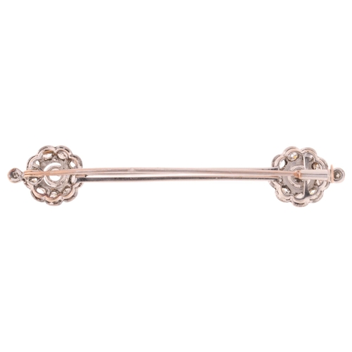 1132 - An Antique 18ct white gold diamond flowerhead cluster bar brooch, circa 1910, each flowerhead set wi... 