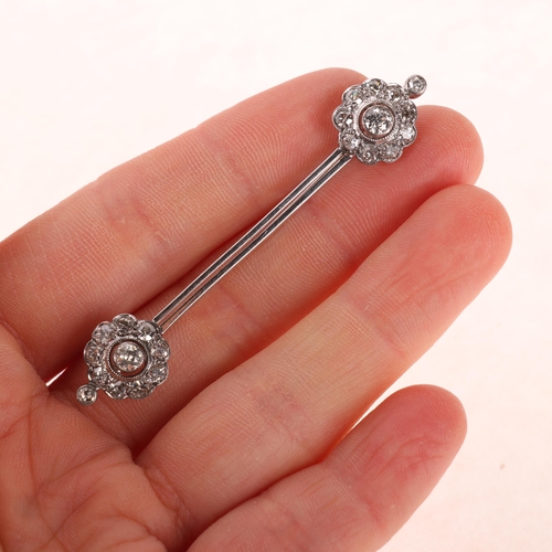 1132 - An Antique 18ct white gold diamond flowerhead cluster bar brooch, circa 1910, each flowerhead set wi... 