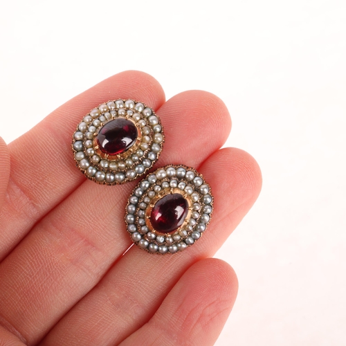 1134 - A pair of Victorian garnet and split pearl mourning earrings, each cut-down collet set with foil-bac... 