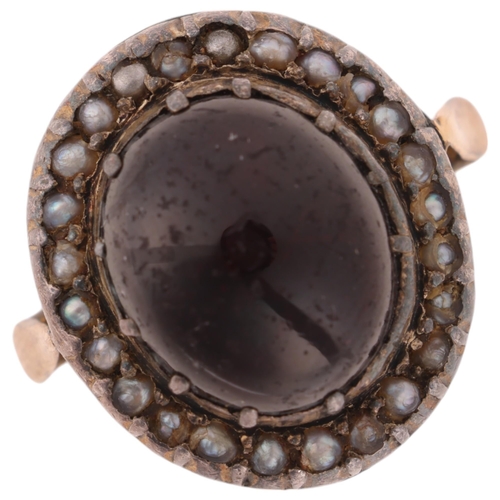 1135 - A Victorian garnet and pearl cluster mourning ring, circa 1880, centrally cut-down collet set with f... 