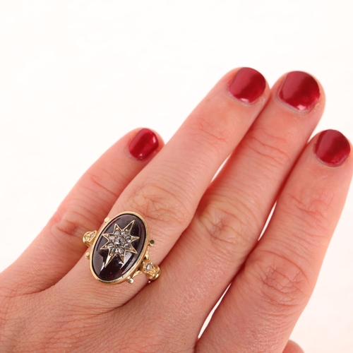 1137 - An Antique Victorian 18ct gold garnet and diamond mourning ring, the central foil-back oval cabochon... 