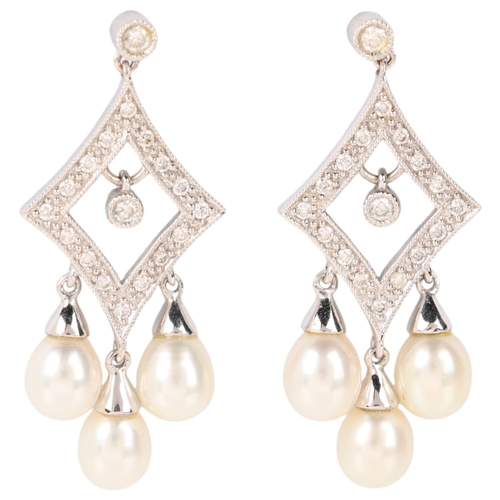 1138 - A pair of 18ct white gold pearl and diamond drop stud earrings, each lozenge set with modern round b... 