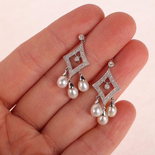 1138 - A pair of 18ct white gold pearl and diamond drop stud earrings, each lozenge set with modern round b... 