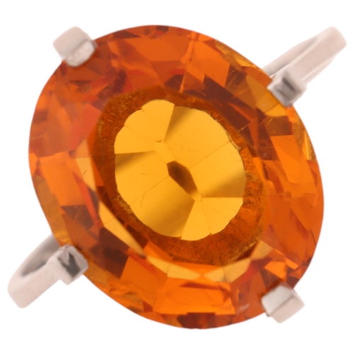 1171 - A platinum single stone citrine dress ring, set with oval mixed-cut citrine, setting height 16mm, si... 