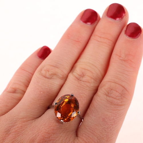 1171 - A platinum single stone citrine dress ring, set with oval mixed-cut citrine, setting height 16mm, si... 