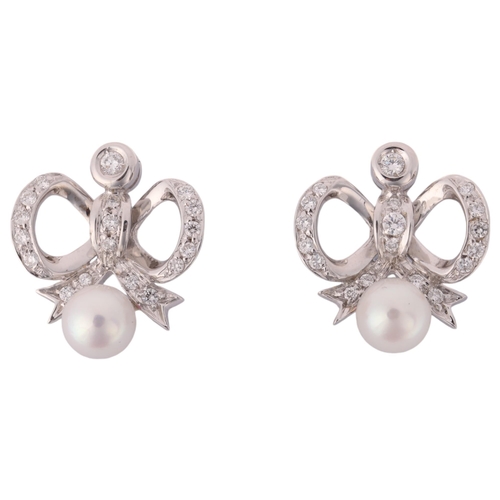 1187 - A pair of 18ct white gold whole pearl and diamond ribbon bow stud earrings, each set with 6mm pearl ... 