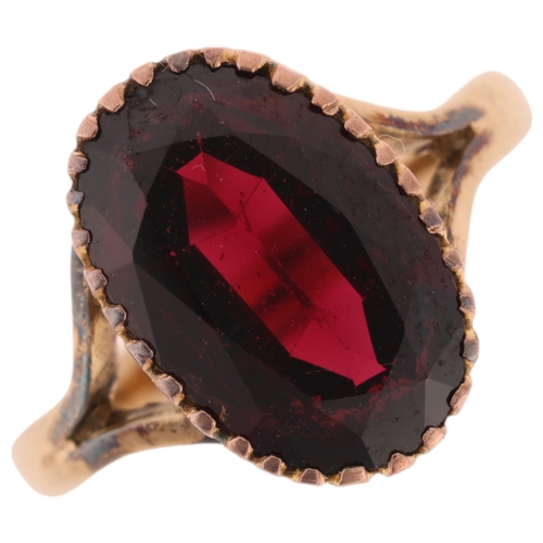 1201 - A 9ct gold garnet dress ring, maker SH, Birmingham 1972, set with oval mixed-cut garnet, setting hei... 