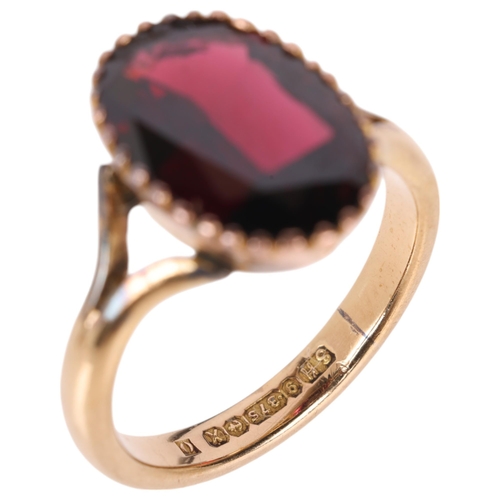 1201 - A 9ct gold garnet dress ring, maker SH, Birmingham 1972, set with oval mixed-cut garnet, setting hei... 