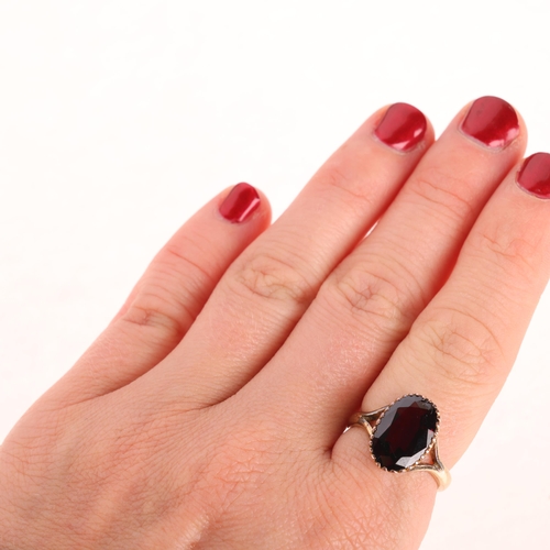 1201 - A 9ct gold garnet dress ring, maker SH, Birmingham 1972, set with oval mixed-cut garnet, setting hei... 