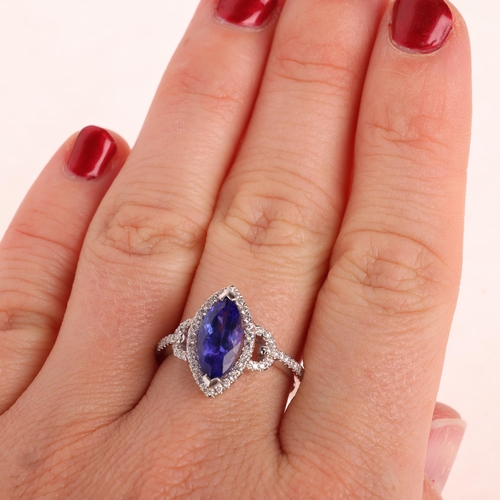 1207 - An 18ct white gold tanzanite and diamond marquise halo cluster ring, set with 1.68ct marquise-cut tr... 