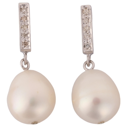 1214 - A pair of 18ct white gold pearl and diamond drop stud earrings, each set with 11.7mm pearl, suspende... 