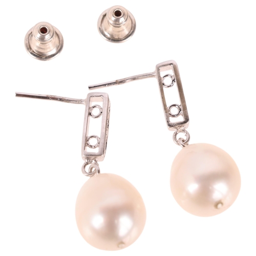 1214 - A pair of 18ct white gold pearl and diamond drop stud earrings, each set with 11.7mm pearl, suspende... 