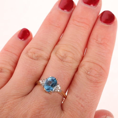 1232 - A 9ct gold blue topaz and diamond dress ring, maker GF Ltd, London 1989, set with oval mixed-cut top... 