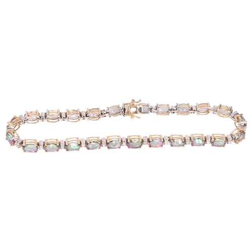 1239 - A modern 9ct gold mystic topaz diamond tennis line bracelet, 19cm, 10g