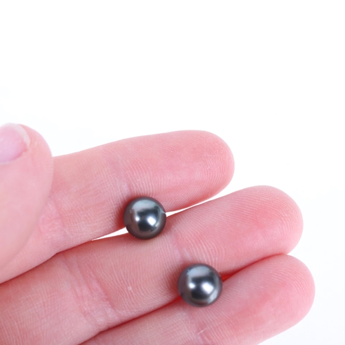 1242 - A pair of 9ct gold whole black pearl stud earrings, each set with 8mm pearl, 1.9g