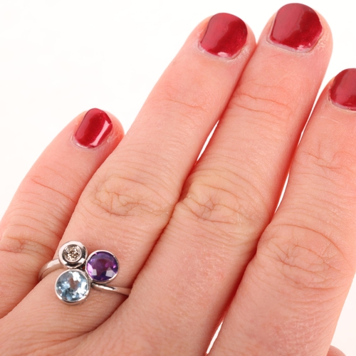 1245 - An 18ct white gold gem set dress ring, set with amethyst blue topaz and diamond, setting height 11.7... 