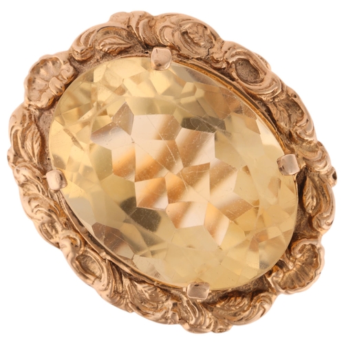 1249 - A large 9ct gold citrine dress ring, maker LGH, set with oval mixed-cut citrine within relief foliat... 