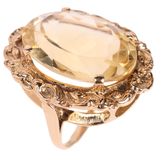 1249 - A large 9ct gold citrine dress ring, maker LGH, set with oval mixed-cut citrine within relief foliat... 