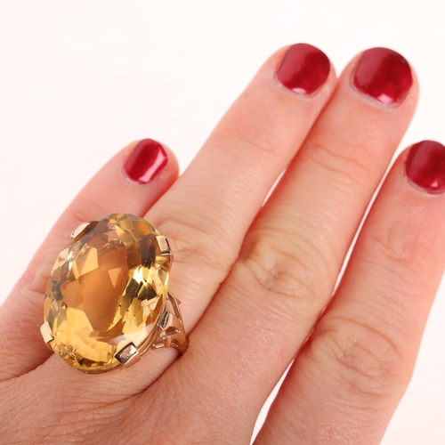 1250 - A large 9ct gold citrine dress ring, set with oval mixed-cut citrine, setting height 27.2mm, size L,... 