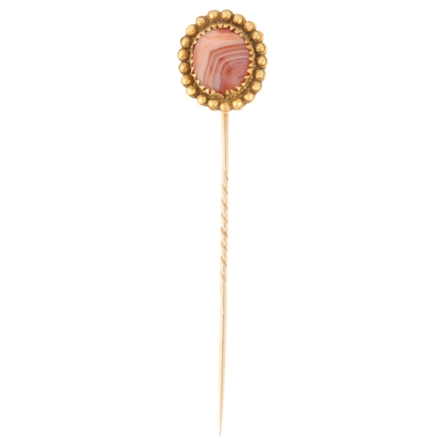 1257 - An Antique Victorian 14ct gold banded agate stickpin, set with round cabochon agate within beaded su... 