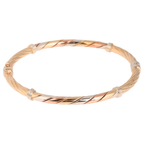 1296 - A 9ct three-colour gold hinged bangle, hallmarks 1996, band width 4.1mm, internal circumference 18cm... 