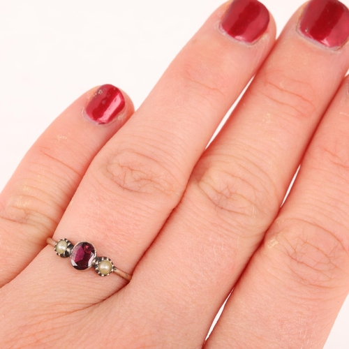 1297 - A Georgian 9ct gold three stone garnet and pearl ring, cut-down collet set with foil back oval-cut g... 